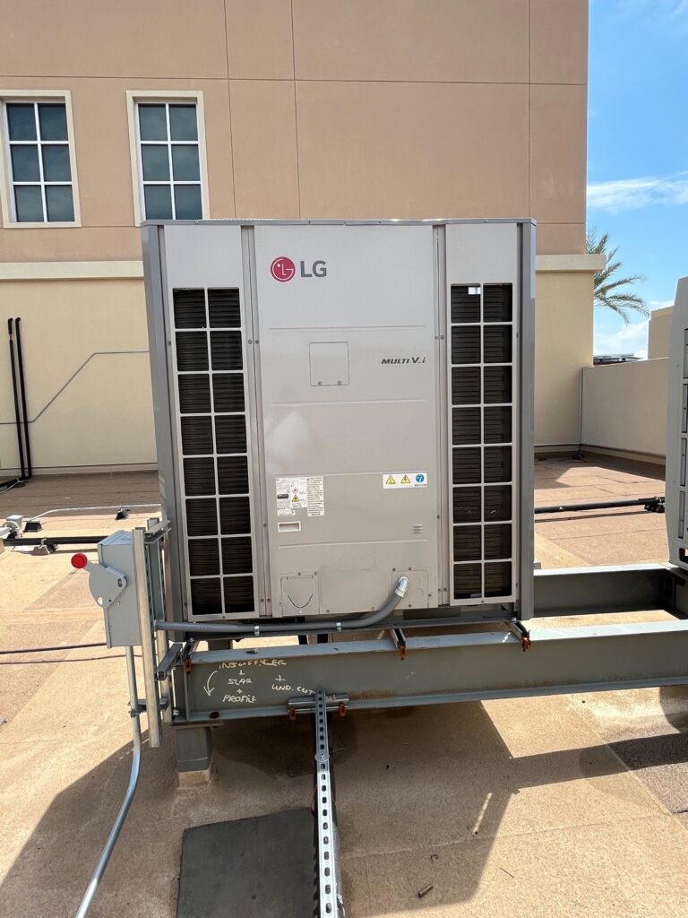 A new LG Multi V i variable refrigerant flow (VRF) outdoor unit sits on a steel frame on a commercial rooftop.